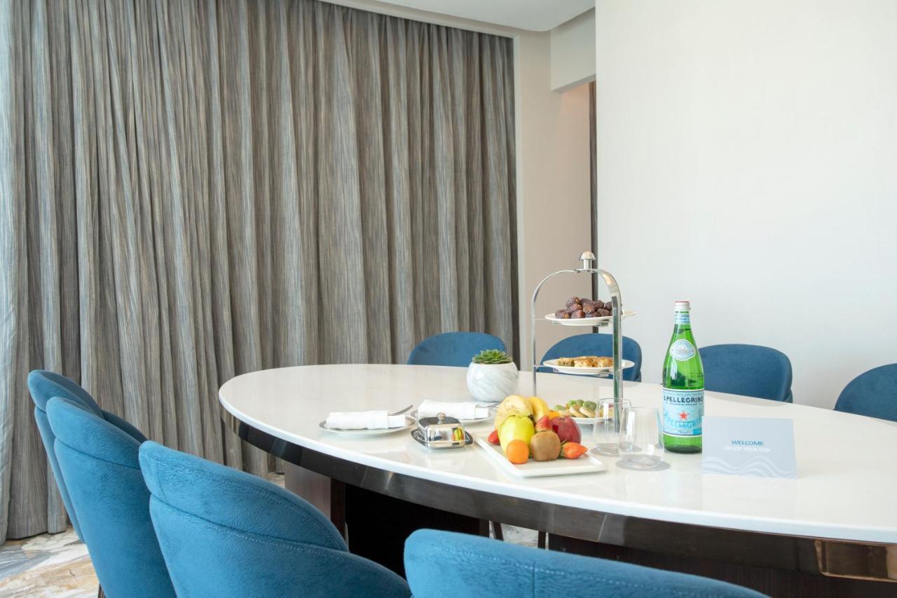 Century Marina Hotel - Lusail 외부 사진 A table with a bottle of mineral water
